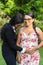 Latin daughter holds her mother`s hands on her pregnant belly