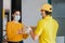 Latin delivery man with mask holding and carrying a cardbox in quarantine coronavirus pandemic