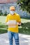 Latin delivery man with mask holding and carrying a cardbox in quarantine coronavirus pandemic