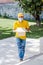 Latin delivery man with mask holding and carrying a cardbox in quarantine coronavirus pandemic