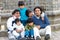 Latin family sitting in the street