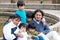 Latin family sitting in the street