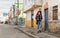 Latin father & son walking on the street while wearing masks to avoid the spread of coronavirus in Bogota, Colombia.