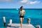 Latin girl running in caribbean pier beach of Mayan Riviera