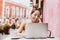 Latin girl, student using portable laptop computer while sitting in a coffee shop in mexico