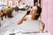 Latin girl, Young woman talking on the phone in coffee shop in Mexico