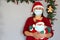 Latin grandmother with protection mask and santa claus hat, christmas decoration and santa claus doll, new normal covid-19