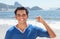 Latin guy at Copacabana beach pointing at Sugarloaf mountain