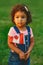 Latin hispanic baby toddler girl holding waving Canadian flag.