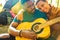 latin hispanic couple in love together in great sunny day in park with guitar and tent