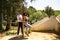 Latin lovers couple leaning on a wooden poster in a sensual way. The man is camouflaging the woman to make her fall in love. They