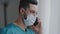 Latin man medical assistant doctor in medical mask consulting patient remote discussing issues by phone hispanic adviser