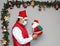 Latin man with protection mask and santa claus doll in christmas decoration, new normal covid-19