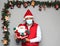 Latin man with protection mask and santa claus doll in christmas decoration, new normal covid-19