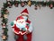 Latin man with protection mask and santa claus doll in christmas decoration, new normal covid-19