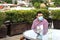 Latin man with protection mask sitting drinking a terrace