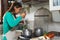 Latin mature woman cooking in old vintage kitchen - Smiling mother preparing lunch