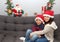 Latin mom and child with protection mask and santa claus hat, christmas decoration, new normal covid-19