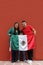 Latin mom, dad and son dressed in the colors of the Mexican flag: green, white and red proud of their tradition and culture of Mex