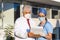 Latin team of medical doctors are looking at camera and smiling while standing outside of mexican hospital in Mexico city or latin