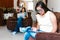 Latin teen girl with down syndrome using a tablet and her mother in the living room, in disability concept in Latin America