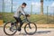 Latin teenage boy with dark hair riding a bike