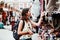 Latin woman backpacker shopping in a Tourist Market in Mexico City, Mexican Traveler in America