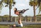 Latin woman and Caucasian man do yoga exercises in a park in Madrid. Balance and concentration in couple