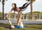 Latin woman and Caucasian man do yoga exercises in a park in Madrid. Balance and concentration in couple