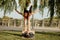 Latin woman and Caucasian man do yoga exercises in a park in Madrid. Balance and concentration in couple