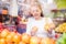 Latin woman choosing oranges citrus in supermarket