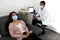 Latin woman and doctor with protection mask in medical exams performing electroencephalogram and brain mapping in times of covid-1