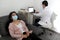 Latin woman and doctor with protection mask in medical exams performing electroencephalogram and brain mapping in times of covid-1