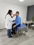 Latin woman doctor specialist ophthalmologist checks the eyes of her dark-skinned male patient suffering from an infection