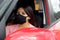 Latin woman driver with protection mask in vehicle interior, new normal when driving