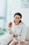 Latin woman holding ripe apple and smiling at camera