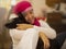 Latin woman hugging her pet, woman with pink scarf on her head due to breast cancer