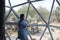 Latin woman inside a geodesic glamping tent with beds and transparent roof to see the sky and stars