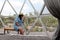 Latin woman inside a geodesic glamping tent with beds and transparent roof to see the sky and stars