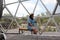 Latin woman inside a geodesic glamping tent with beds and transparent roof to see the sky and stars