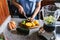 Latin Woman making green smoothie or Detox juice in kitchen at Home in healthy eating concept in Mexico