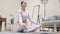 Latin Woman Meditating on Yoga Mat at Home