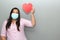 Latin woman with protection mask clinical use and red heart, valentine in contingency covid-19