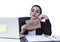 Latin woman showing help sign desperate suffering stress at work while sitting at office laptop