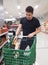 Latin young man loading hard nougat into the trolley