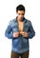 Latin young man opening denim shirt on naked chest