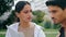 Latina couple reading documents outdoors closeup. Serious coworkers working park