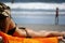 Latina lady in body wearing black bikini getting sun bath for tanning on the beach bed at the Caribbean coast of Manuel Anton