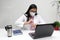 Latina medical doctor woman with glasses, white coat and face mask gives consultation and teaches how to wash hands remotely by vi