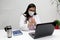 Latina medical doctor woman with glasses, white coat and face mask gives consultation and teaches how to wash hands remotely by vi